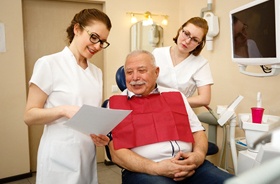 Patient and dentist discussing candidacy for All-on-4 treatment