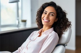 Smiling, beautiful woman in dental treatment chair