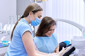 Patient and dental team member looking at tablet