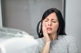 Woman with toothache visiting her Torrington emergency dentist