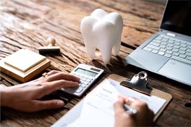 Figuring the cost of dental care with calculator