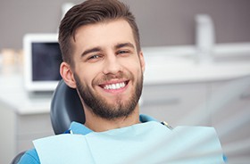 Male patient smiling after dental implant placement surgery