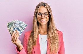 Smiling, happy woman holding cash