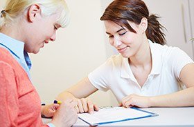 Patient checking in at reception desk