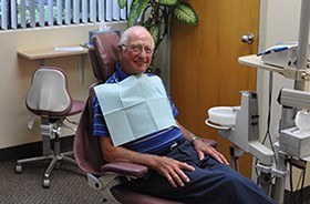 Smiling older man in dental chair