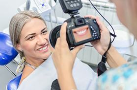 Dentist taking picture of patient's smile