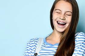 Happy teenager in striped shirt with braces in Torrington