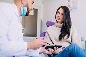 Dental patient speaking to dentist, enjoying benefits of professional orthodontic care