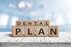 Dental plan written on wooden blocks, stacked on tabletop
