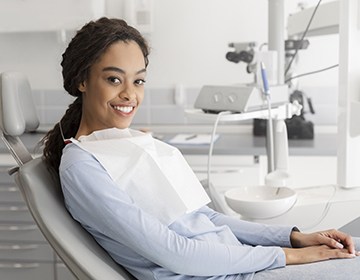 Woman checking in at dental reception desk