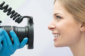 Dentist capturing photo of patient's smile