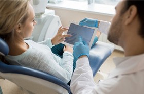 Dentist and patient discussing details of treatment plan