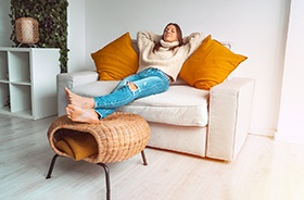 Woman relaxing on sofa at home