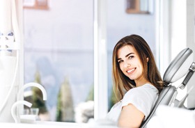 Female patient smiling after successful dental implant salvage