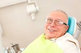 Smiling senior patient after successful dental implant salvage