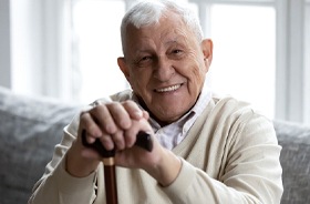 Smiling senior man enjoying benefits of implant dentures