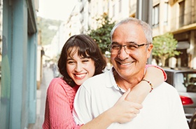 Father and adult daughter, both potential candidates for dental implants