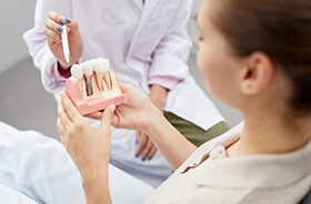 Woman learning about the cost of dental implants in Torrington