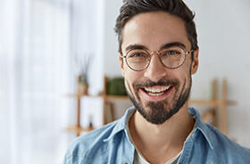 young man with dental implants in Torrington