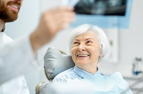 Dentist holding up x-ray