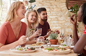 Happy group of friends enjoying a meal together