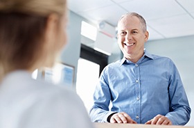 Man talking with front desk staff