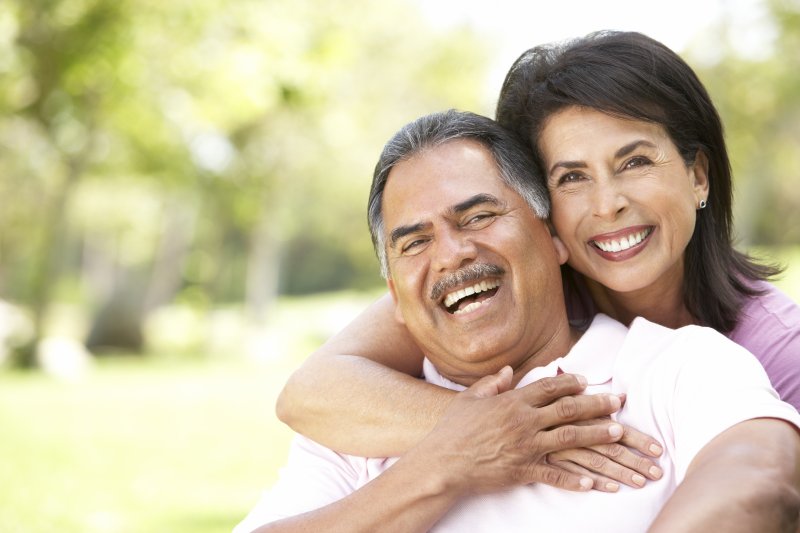 an older couple hugging and smiling