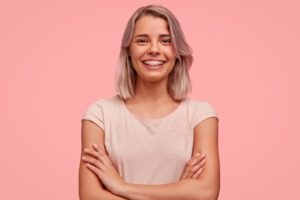 Smiling woman in pink shirt during her braces treatment time