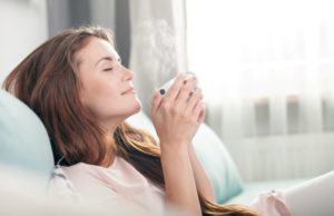 Woman relaxing and sipping coffee