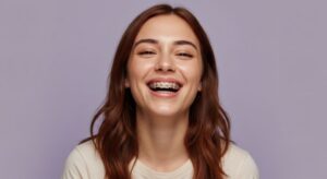 Portrait of happy young woman wearing braces to straighten her teeth 